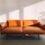 Orange couch by a window