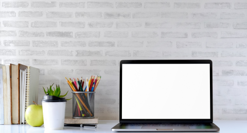 Laptop on a desk with a white background