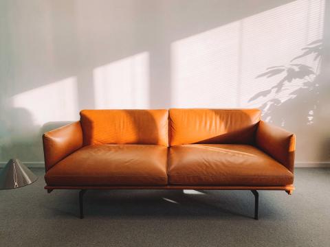 Orange couch by a window