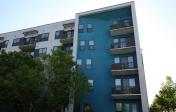 Blue and white apartment building in Austin, Texas surrounded by trees