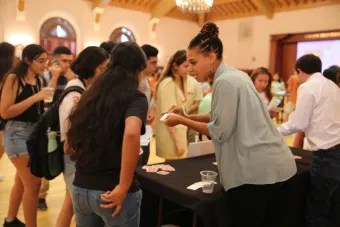 Students talking to people at a booth