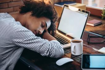 Woman sleeping on a laptop