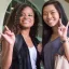 Two women doing the horns sign