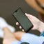 Person sitting while looking at a phone