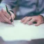 Man filling out a pile of papers