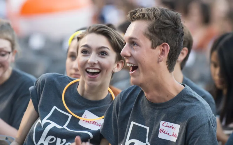 Two students smiling at event