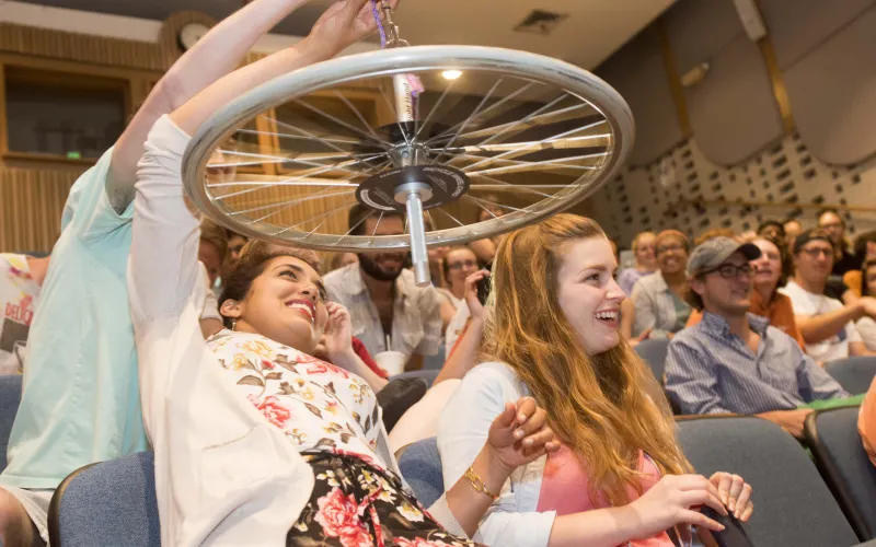 Students playing with a wheel in a physics circus