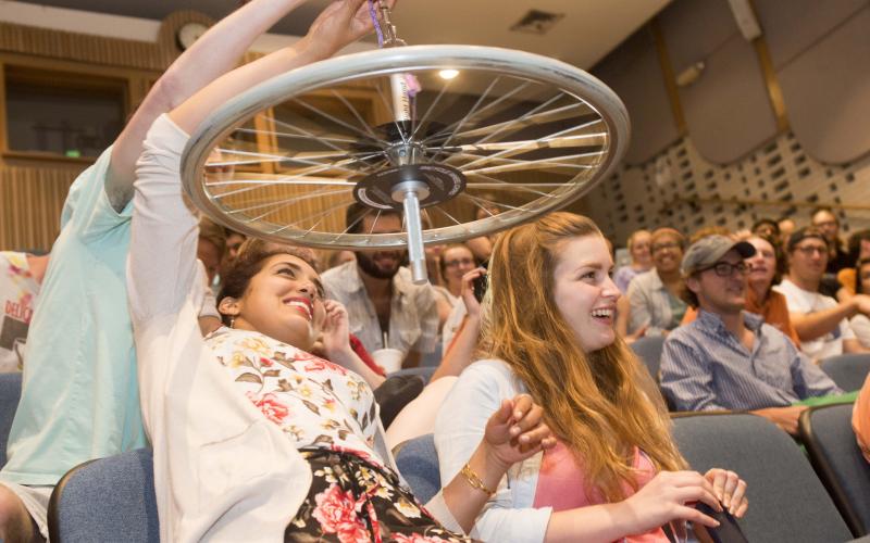 Students playing with a wheel in a physics circus